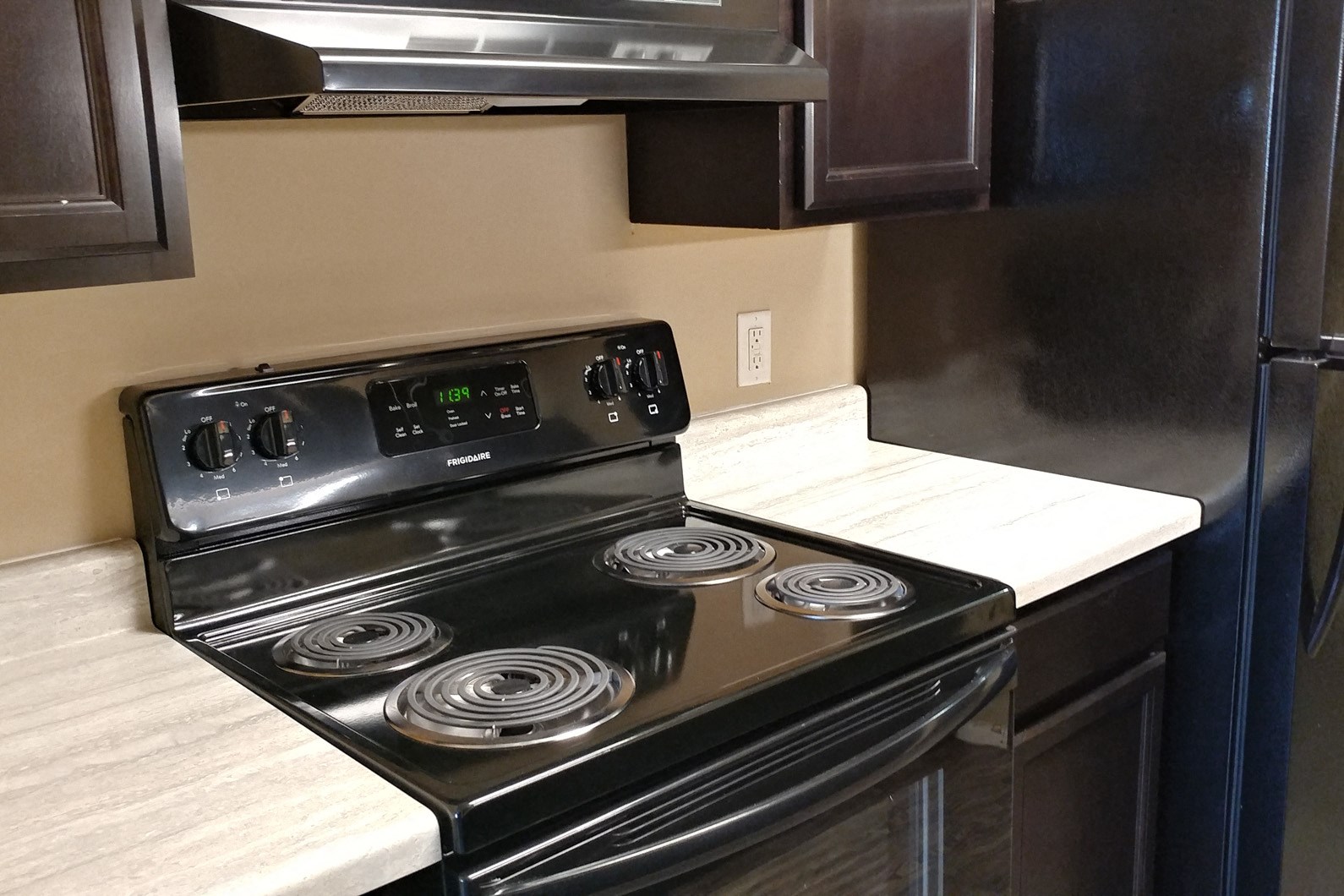 Remodeled kitchen with dark appliances at Fox Ridge Apartments, Omaha, NE